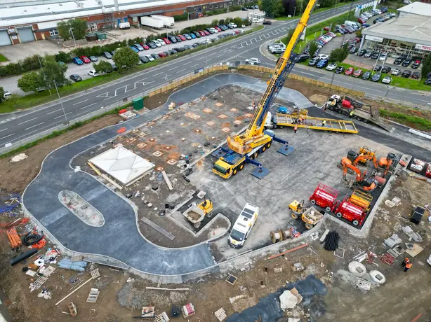 crane lifting building modules into place - commercial drone services