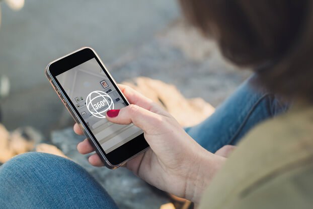 woman looking at 360 tour on mobile phone